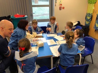 Future nurses and children in discussion round a table